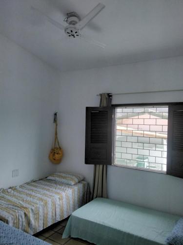 a bedroom with two beds and a window at Doce lar do Ipase in São Luís