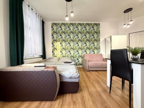 a bedroom with a bed and a desk and a chair at w Centrum in Inowrocław