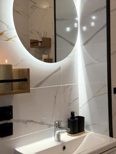 a bathroom with a sink and a mirror at w Centrum in Inowrocław