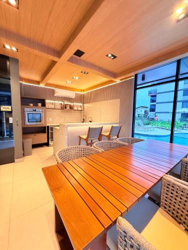 a dining room with a wooden table and chairs at Resort beira mar in Porto De Galinhas