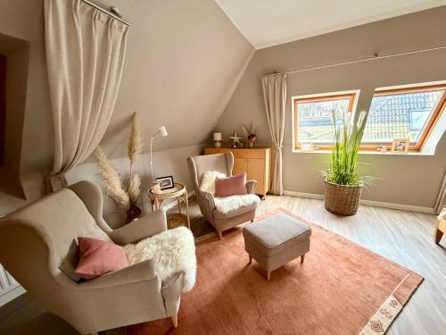 a living room with two chairs and a window at Strandbrise App 17 in Neuhaus
