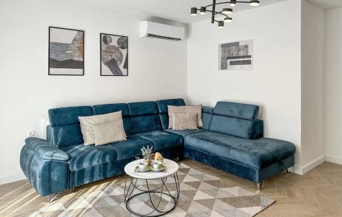 a living room with a blue couch and a table at Villa Ika in Gomila