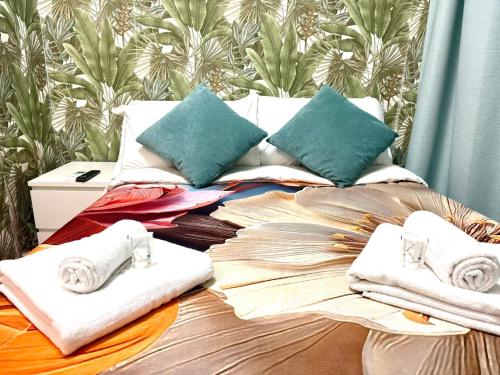 a bed with towels and pillows on top of it at Vittorio Central Park Guest House in Rome