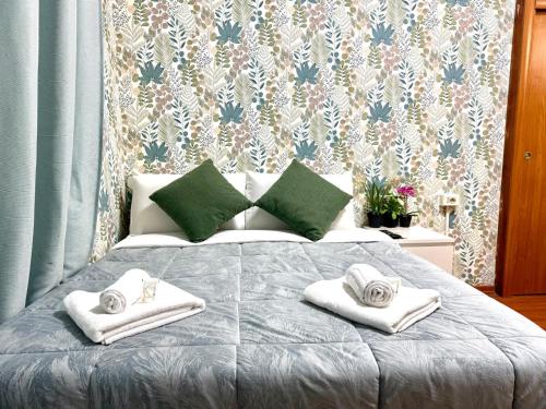 a bedroom with a bed with towels on it at Vittorio Central Park Guest House in Rome