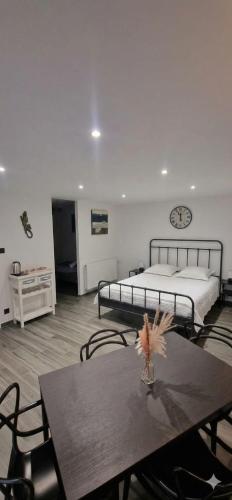 a bedroom with a bed and a table and chairs at Chez fina in Ath