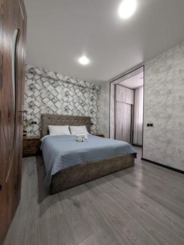 a bedroom with a bed and a door to a room at Gari's apartment next to Borjomi Central Park in Borjomi