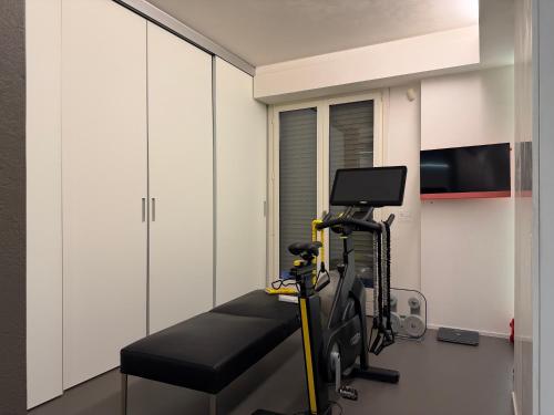 a room with a gym with a treadmill at Cortirola luxury apartment in Pesaro