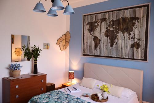 a bedroom with a bed and a map on the wall at Casa Luce in Caltabellotta