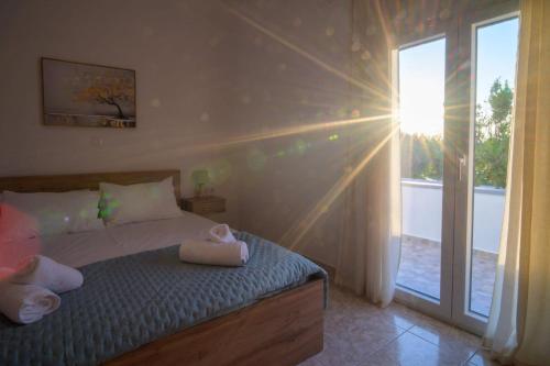 a bedroom with a bed with towels on it at Arezina's Apartment in Vromolithos