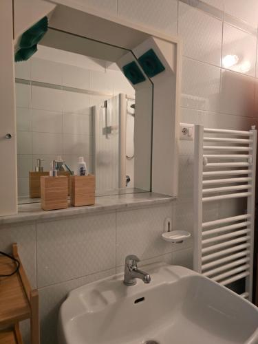 a bathroom with a sink and a mirror at Alloggio turistico Dedicato in Gaeta