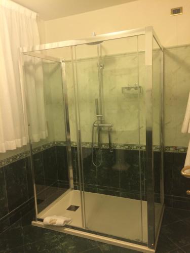 a shower stall with a glass shower door at Suite Hotel Nettuno in Sestri Levante