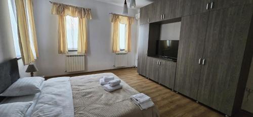 a bedroom with a bed with two teddy bears on it at Vila Alexandra - Prime accomodation - Pumo Properties in Bucharest