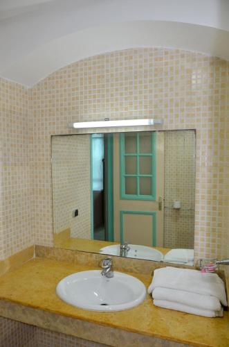 a bathroom with a sink and a mirror at HOTEL AZOuR in Agadir