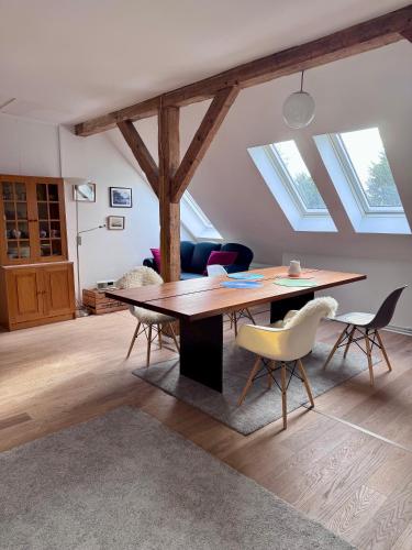 a living room with a wooden table and chairs at Altes Zollhaus in Borkum
