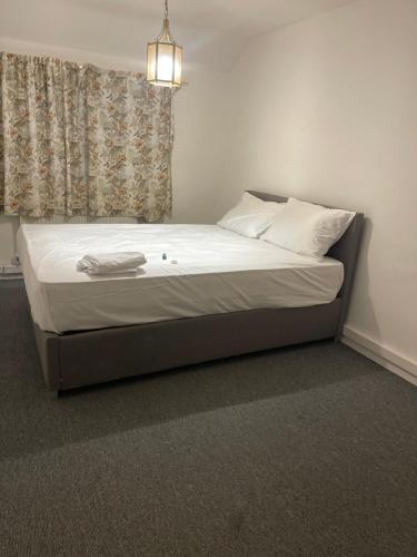 a bed with white sheets and pillows in a bedroom at Ermihouse in Sheffield