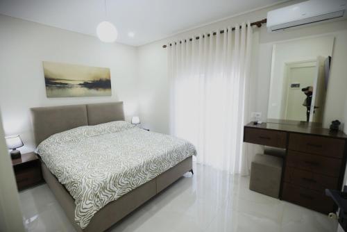 a bedroom with a bed and a dresser and a mirror at The Swan Nest 2 in Pogradec