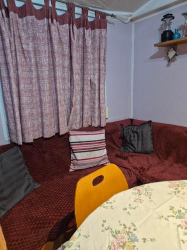 a living room with a bed and a window at Casa da praia fluvial o Moinho in Benquerença