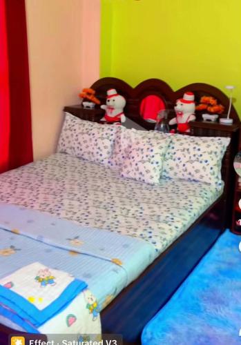 a bedroom with a bed with santa clauses on it at Naranthan daura chulo homestay in Panaoti