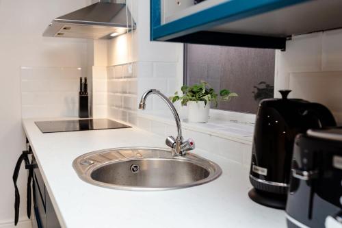 a kitchen counter with a sink in a kitchen at Stylish Studio with Parking in Doncaster in Doncaster