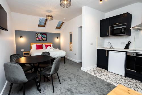 a room with a bed and a table and chairs at Loft-Style Studio with Skylights and Parking in Doncaster