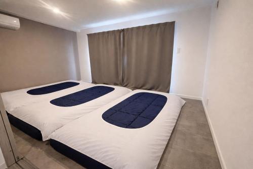 two beds in a small room withthritisthritis at COTO Shibuya Premium Garden in Tokyo