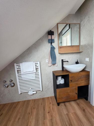 a bathroom with a sink and a mirror at Modern apartment in downtown in Schwäbisch Hall