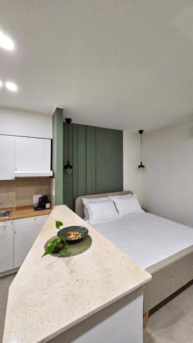 a bedroom with a large bed with a bowl on a counter at MASA 2Rooms in Piazza Armerina