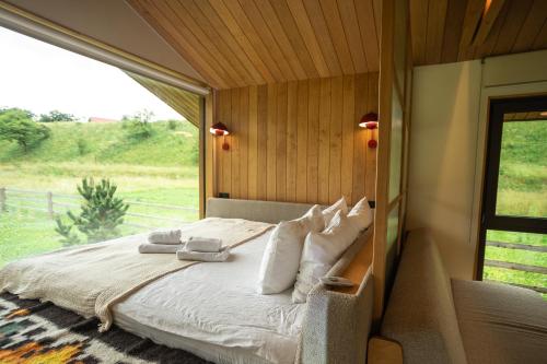 a bed in a room with a large window at porichka in Korostov