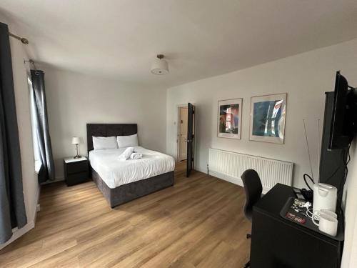a bedroom with a bed and a television in it at Tuam House in Plumstead
