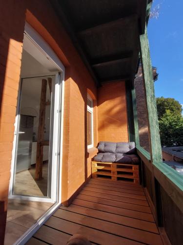 a porch with a bench and a window on a house at City Residenz Jena - modern, groß, ruhig, zentral, 2 Balkone, 4 Zimmer, Küche, Bad in Jena