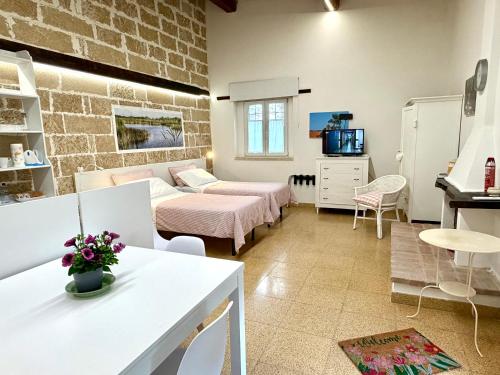 a living room with a bed and a tv at Masseria La Torre in Maglie