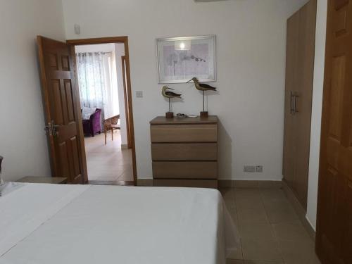 a bedroom with a bed with two lamps on a dresser at Residence Poolside Haven in Grande Gaube