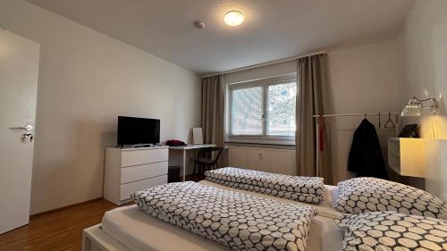 a bedroom with two beds and a television in it at ask rooms Privatzimmer in Kassel in Kassel