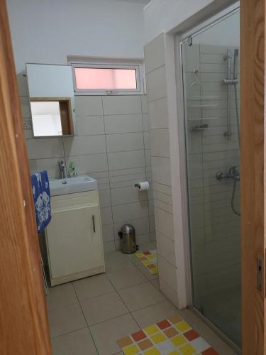 a bathroom with a glass shower and a sink at Residence Poolside Haven in Grande Gaube