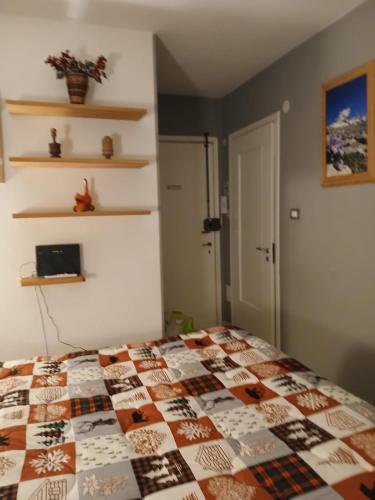 a bedroom with a bed with a quilt on it at Il Mughetto in Aosta
