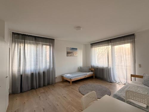 a living room with white walls and large windows at Ferienwohnung Oppenheim in Oppenheim