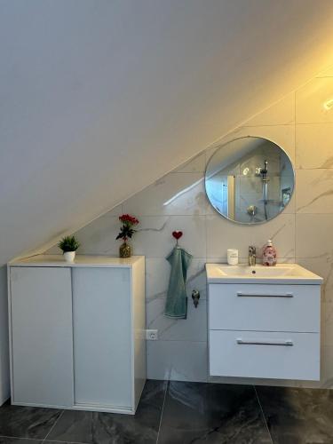 a bathroom with a sink and a mirror at Apartment D&A in Albbruck