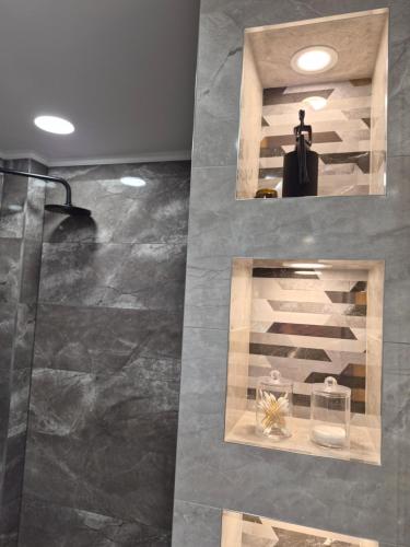 a room with a marble floor and a mirror at The View -Balkan Tower безплатно паркомясто in Gabrovo