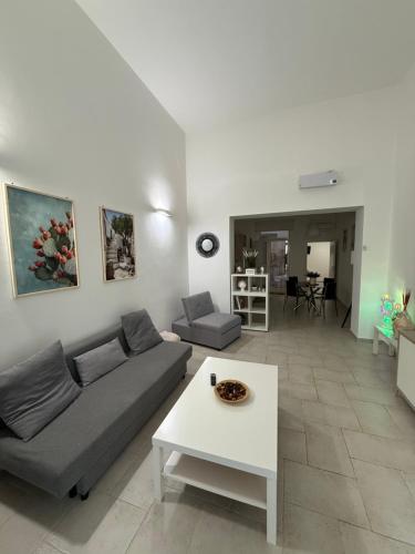 a living room with a couch and a table at Apulian Dreams in Brindisi