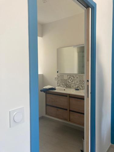a bathroom with a sink and a mirror at Gîte Les Douets in Isigny-le-Buat