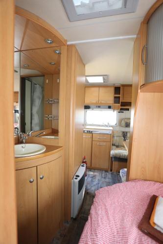 a small bathroom with a sink and a sink at "Campingplatz Altjessen 57" in Pirna