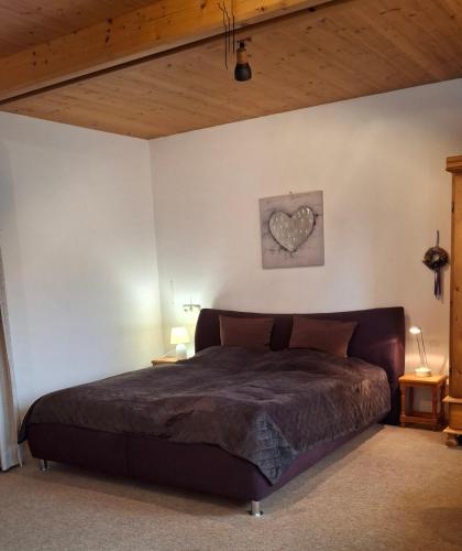 a bedroom with a bed with a heart on the wall at Stadthaus Sonneneck in Bad Tölz