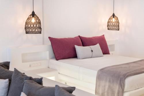 a white room with a couch and some pillows at Anna Platanou Suites in Agia Irini Paros