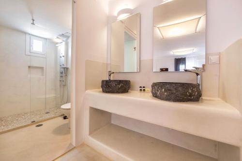 a bathroom with a sink and a mirror at Anna Platanou Suites in Agia Irini Paros