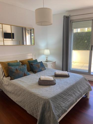 a bedroom with a large bed with two pillows on it at Apartment by the sea & town in Esposende
