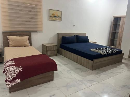 a bedroom with two beds in a room at Duplex sahrawi in Nouakchott