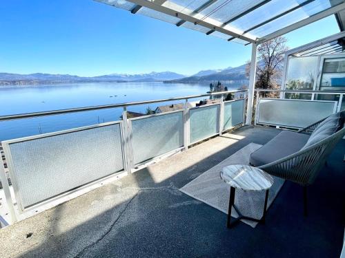 a balcony with a view of a body of water at Horizon 62 I Zürich Lakeside Apartment I Modern I Free Parking I Self-Check-In in Richterswil
