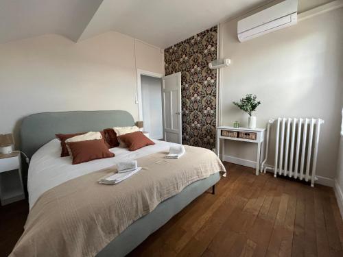 a bedroom with a large bed and a radiator at Maison WILSON in Blois