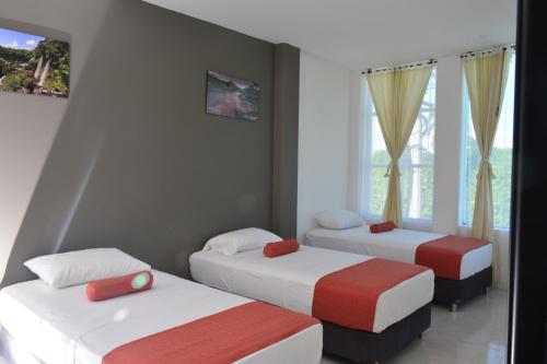 Una cama o camas en una habitación de Hotel Confort Ariari