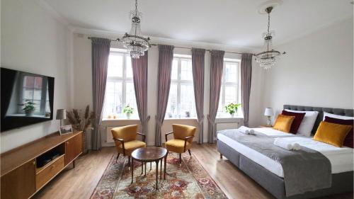 a bedroom with a bed and a table and chairs at Old Town Gdansk Olives Marina Apt 2 min walk to Motlawa River in Gdańsk